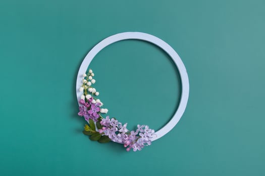 Summer or spring composition. Lily of the valley flowers with round frame copy space top view. Summer, spring floral concept photo
