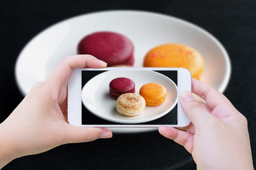 Colorful macarons with phone photo