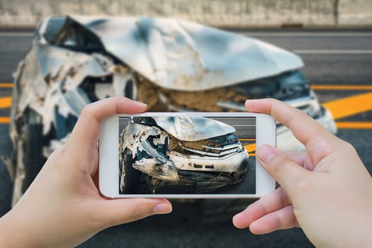woman using smartphone take photo of car crash accident on the road
