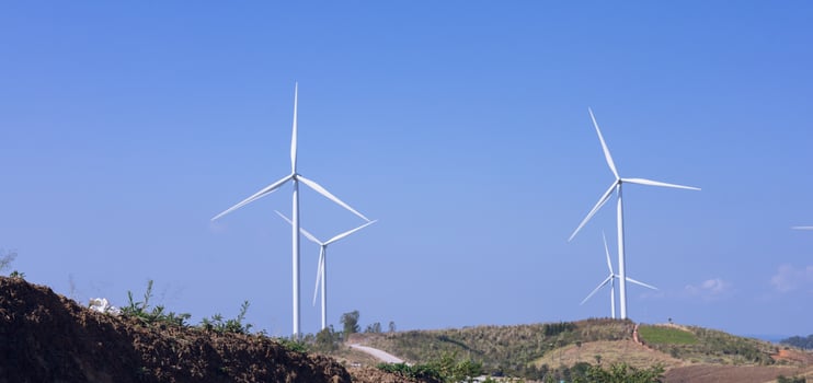 Offshore wind power and energy farm with many wind turbines on the mountain photo