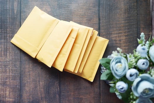 yellow paper bubble envelope on table photo