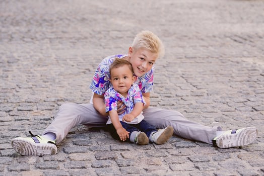 caucasian adorable cute boys siblings holding each other in sunny day outdoor. Family, help, support concept photo