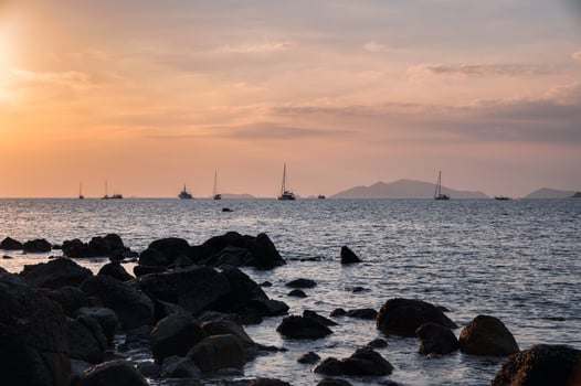 Yachts sightseeing sunset in tropical sea photo