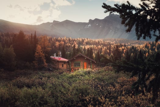 Wooden huts with rocky mountains and sunshine on autumn deep forest in the morning at Assiniboine provincial park photo