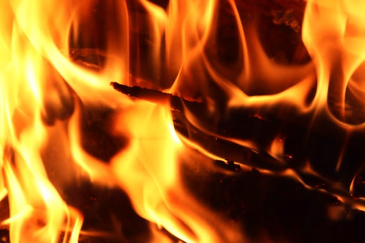 Beautiful red and orange hot burning fire in a fireplace photo