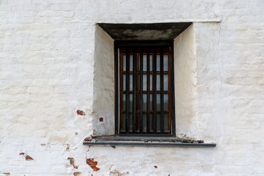 window with bars in an old medieval castle. photo