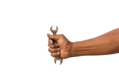 The mechanic is holding an old wrench isolated photo