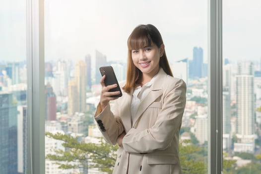 Young beautiful Business Woman using smart phone in modern office photo