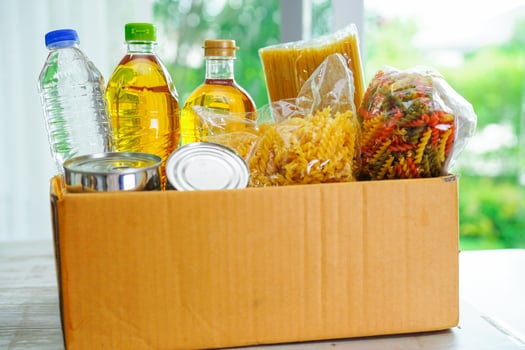Foodstuffs in donation box for volunteer. photo