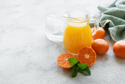 Jug of fresh orange tangerine juice photo