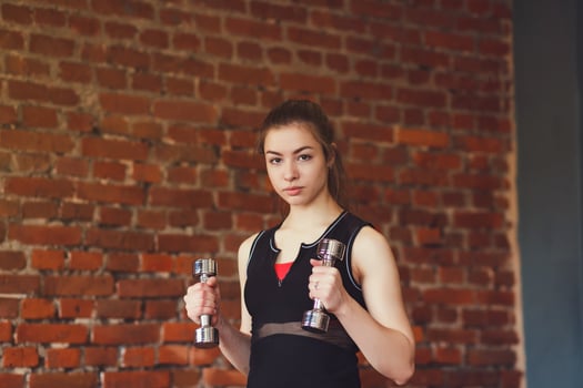 Active sportive athletic woman with dumbbells photo