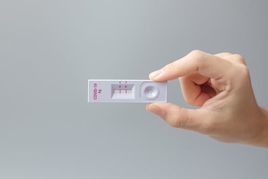 man holding Rapid Antigen Test kit with Positive result during swab COVID-19 testing. Coronavirus Self nasal or Home test, Lockdown and Home Isolation concept photo