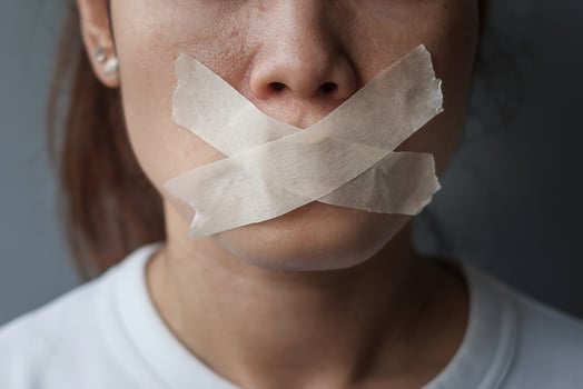 woman with mouth sealed in adhesive tape. Free of speech, freedom of press, Human rights, Protest dictatorship, democracy, liberty, equality and fraternity concepts photo