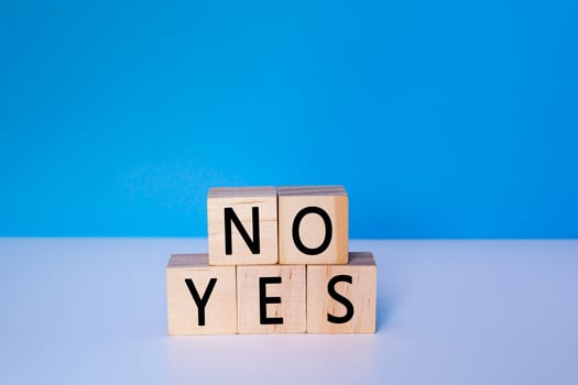 Yes and No on wooden cube. Decision, choosing and answer concept. photo