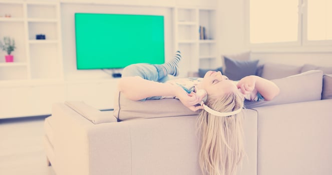 girl enjoying music through headphones photo