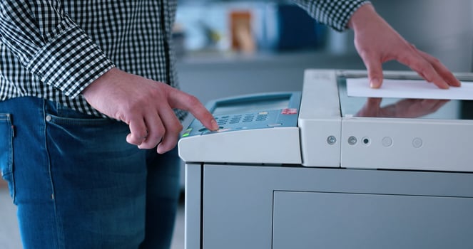 Male Assistant Using Copy Machine in modern office photo