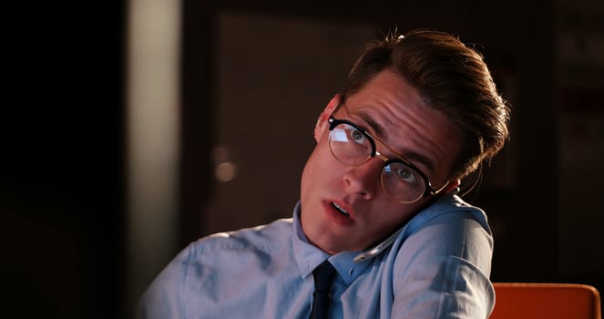 man using mobile phone in dark office photo