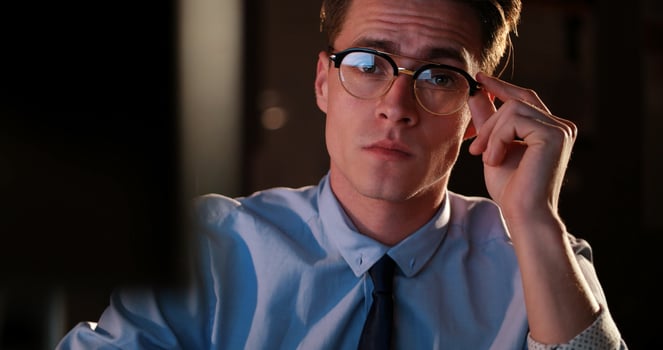 man working on computer in dark office photo