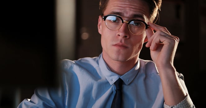 man working on computer in dark office photo