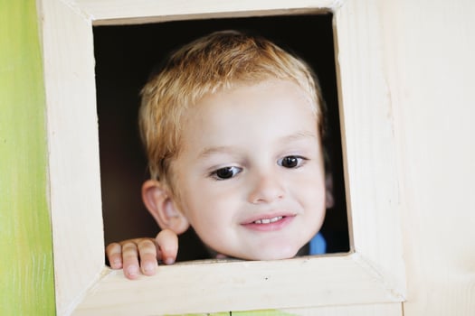 happy child in a window photo