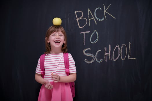 child holding apple on head photo