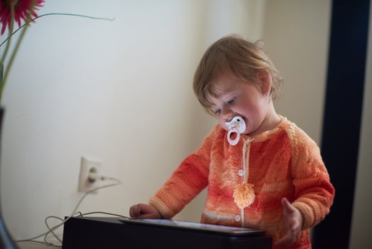 baby playing with tablet at home photo
