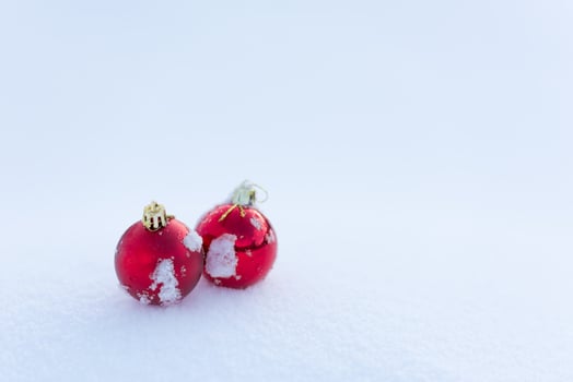 red christmas balls in fresh snow photo