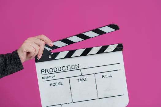 movie clapper on pink background photo