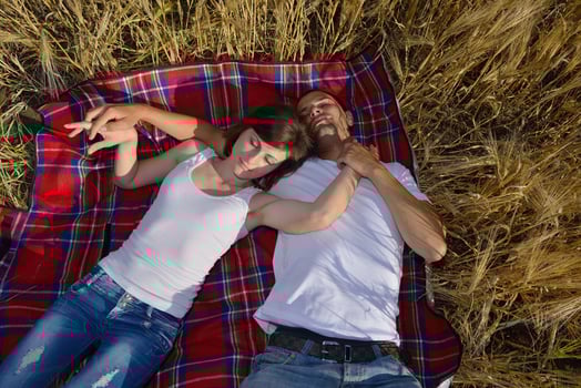happy couple in wheat field photo