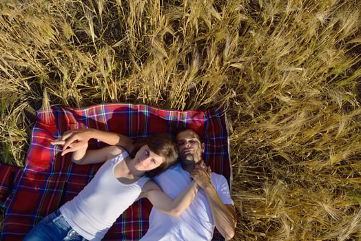 happy couple in wheat field photo