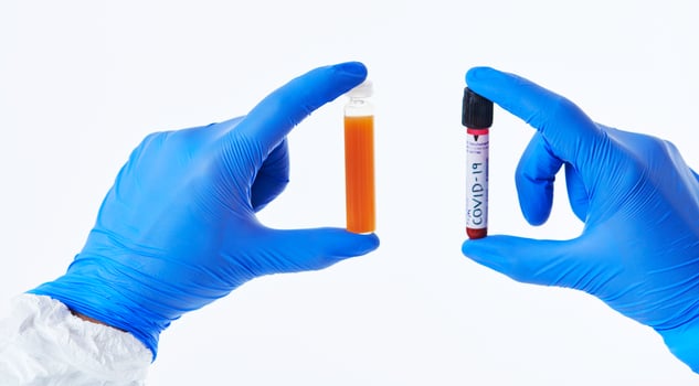 Coronavirus, Doctor holding positive covid-19 virus Blood Sample tube white background photo