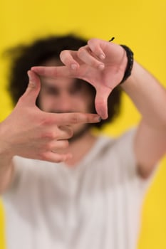 young man with funny hair over color background photo