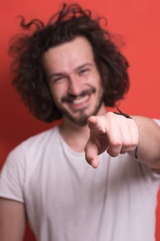 young man with funny hair over color background photo