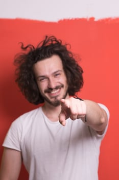 young man with funny hair over color background photo