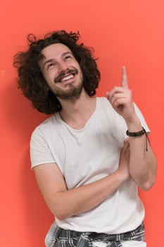 young man with funny hair over color background photo