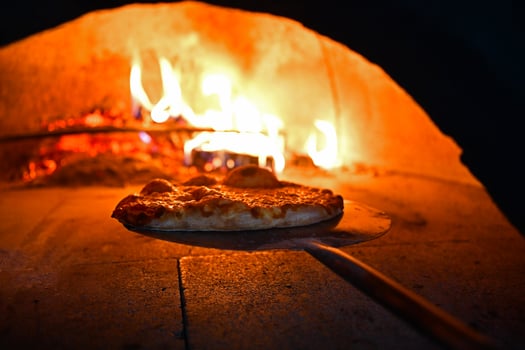 rustic pizza in wood fired oven photo