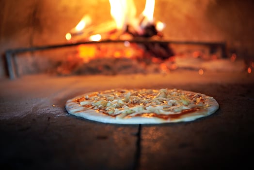 rustic pizza in wood fired oven photo