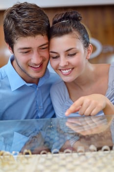 happy young couple in jewelry store photo