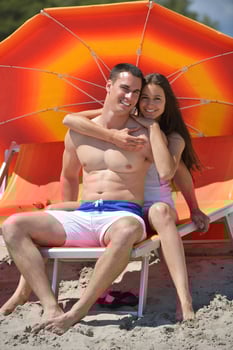 happy young couple have fun on beach photo
