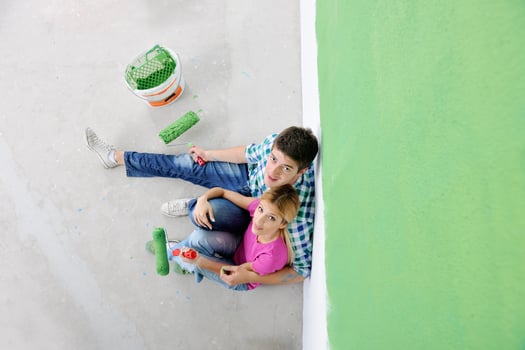 happy young cople relaxing after painting in new home photo