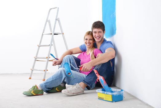 happy young cople relaxing after painting in new home photo