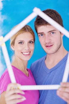 happy couple paint wall at new home photo