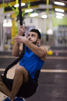man doing rope climbing photo