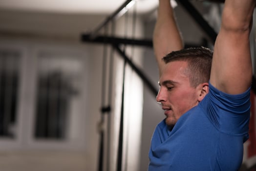 man doing pull ups photo
