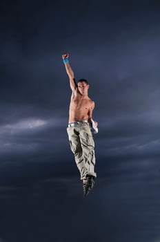 young man dancing and jumping  on top of the building photo