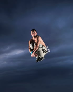young man dancing and jumping  on top of the building photo