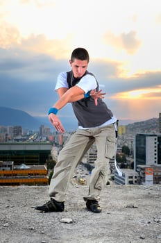 young man jumping in air outdoor at night ready to party photo
