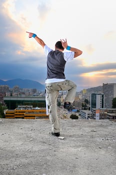 young man jumping in air outdoor at night ready to party photo