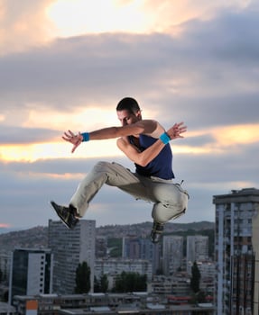 young man jumping in air outdoor at night ready for party photo