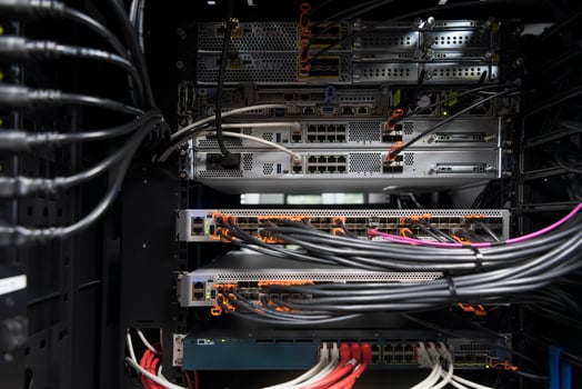 network server room closeup on fiber optic hub or switch for digital communications and internet in mainframe corporate business data center supercomputer. photo